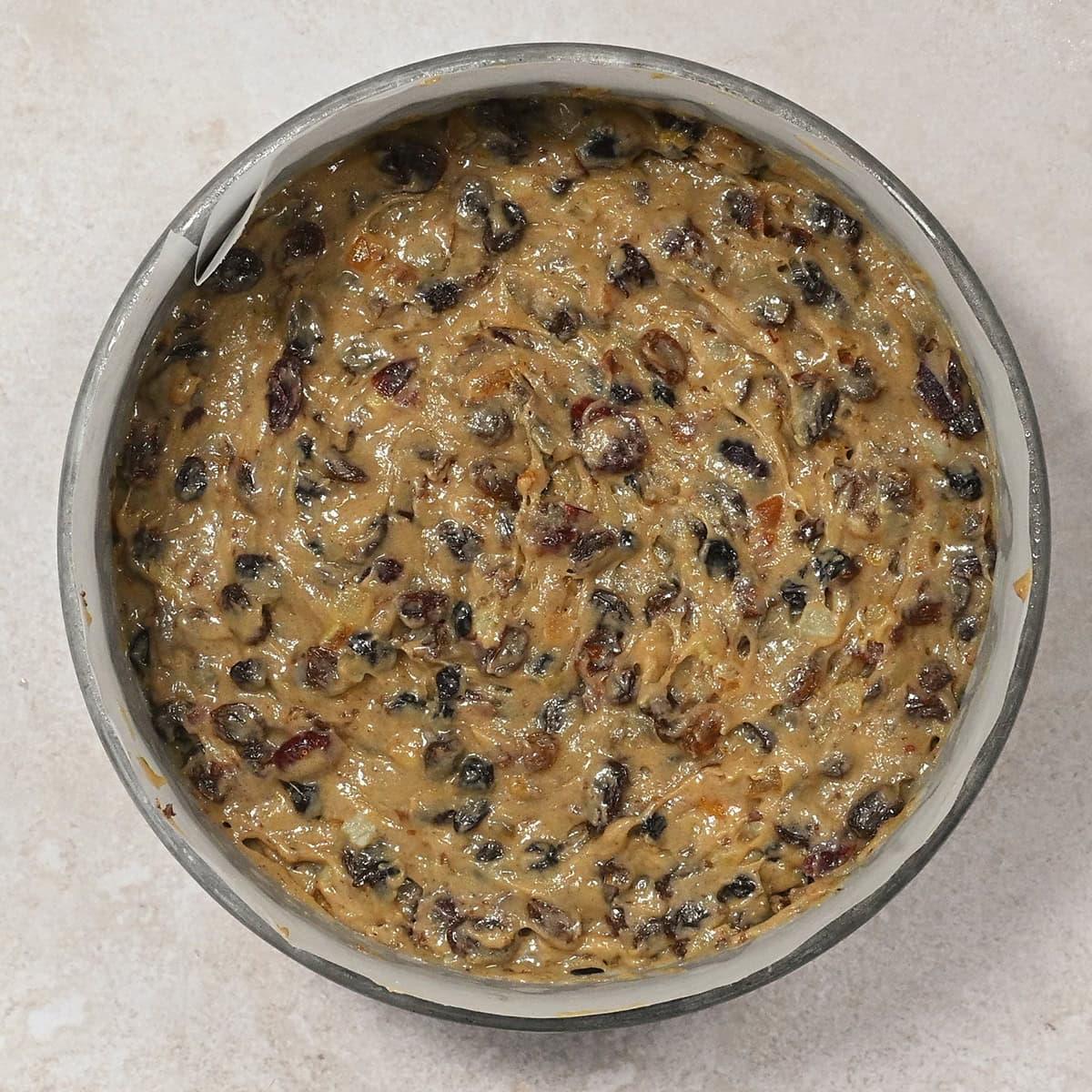 fruitcake batter in a cake tin prior to baking