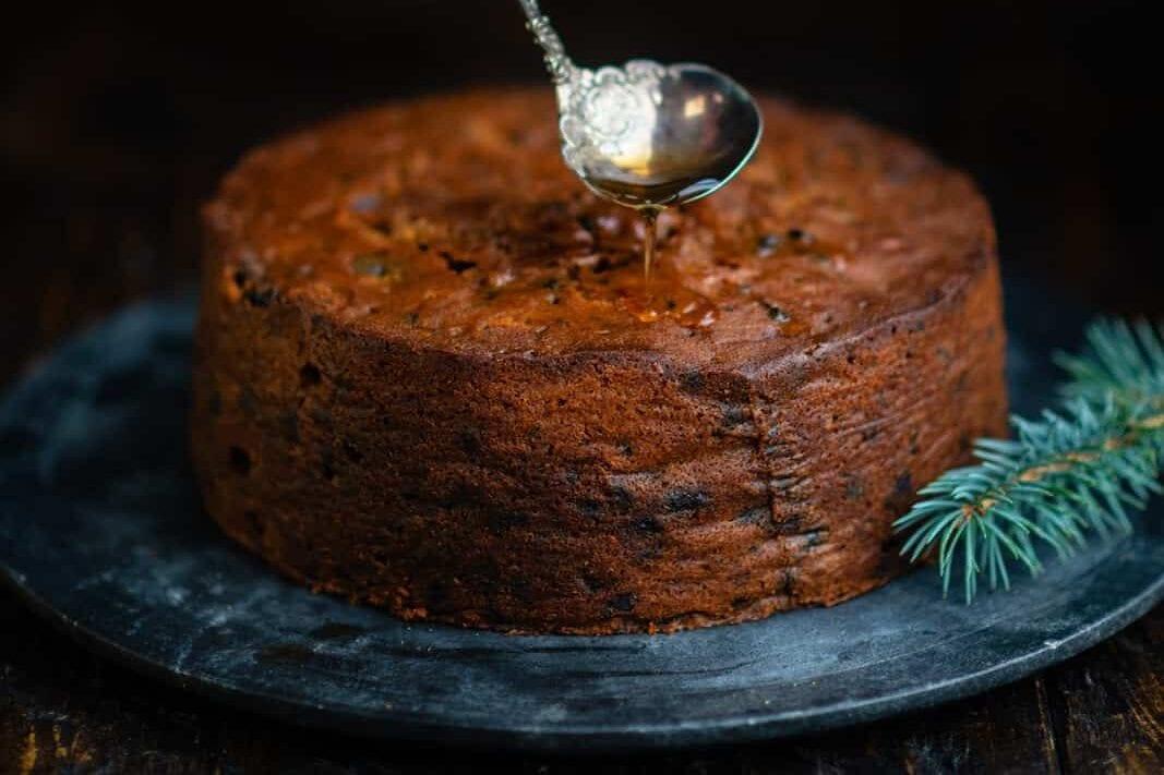 Feeding Christmas fruit Cake with brandy