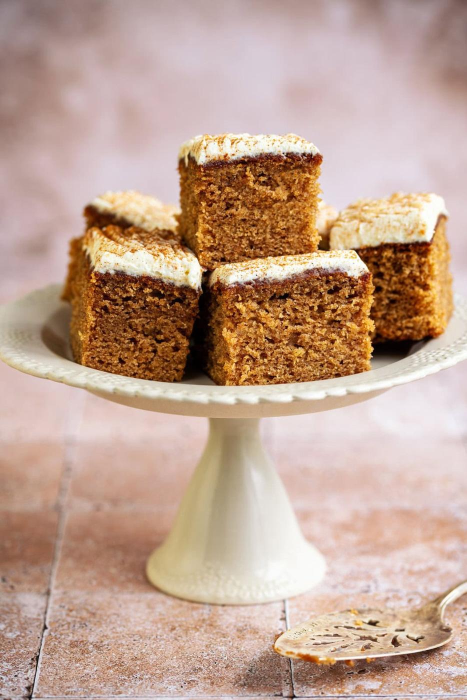 Air Fryer Apple cake, cut into squares and piled on a cream cake stand
