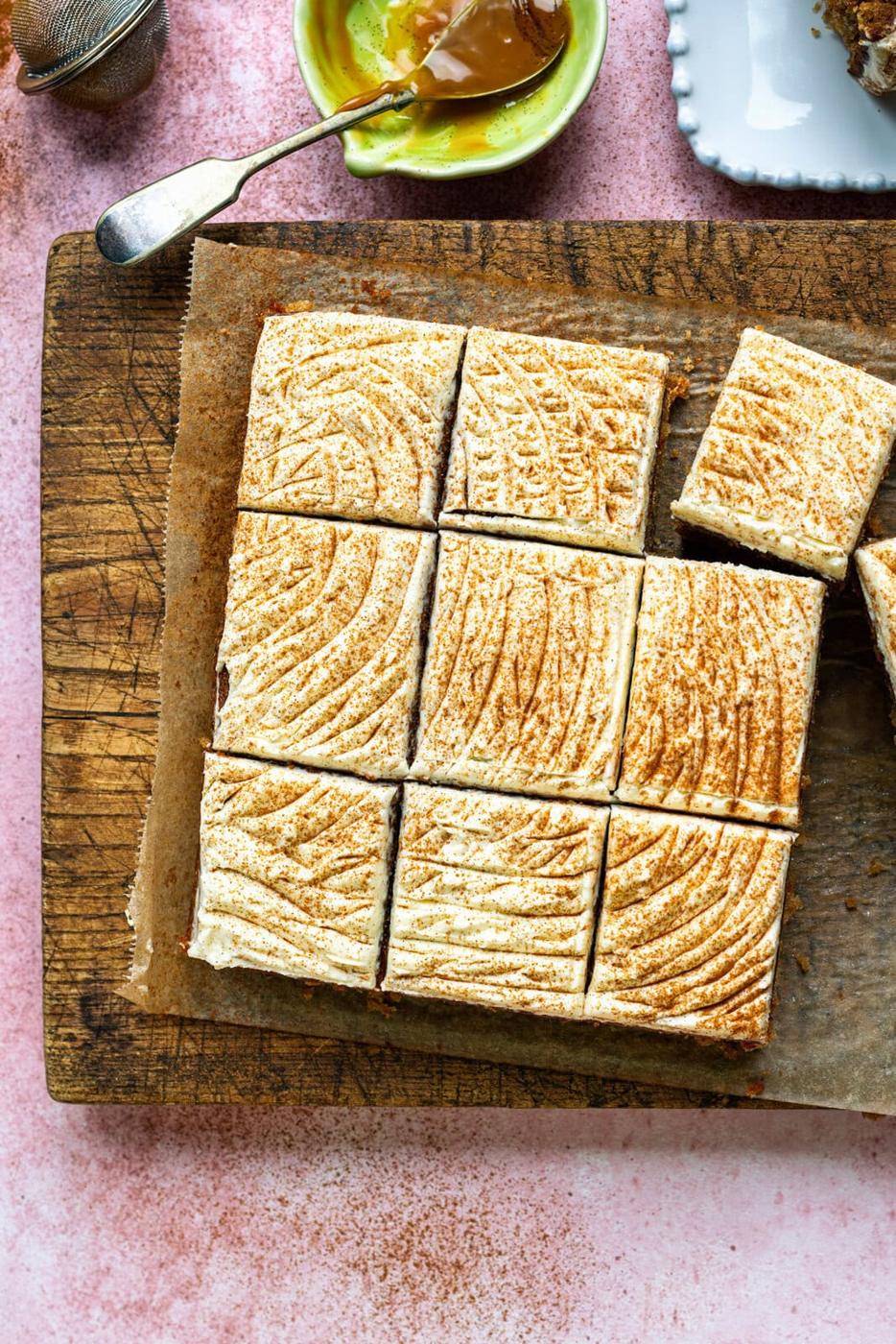 Overhead view of sliced apple cake with cream cheese frosting