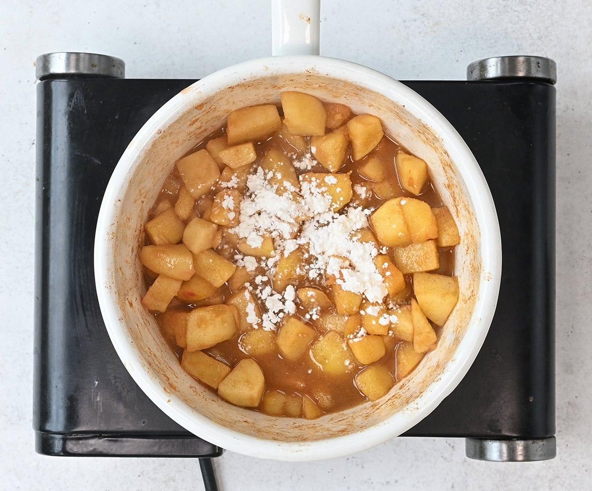 apple crumble filling thickened in a saucepan, ready for the pie dish