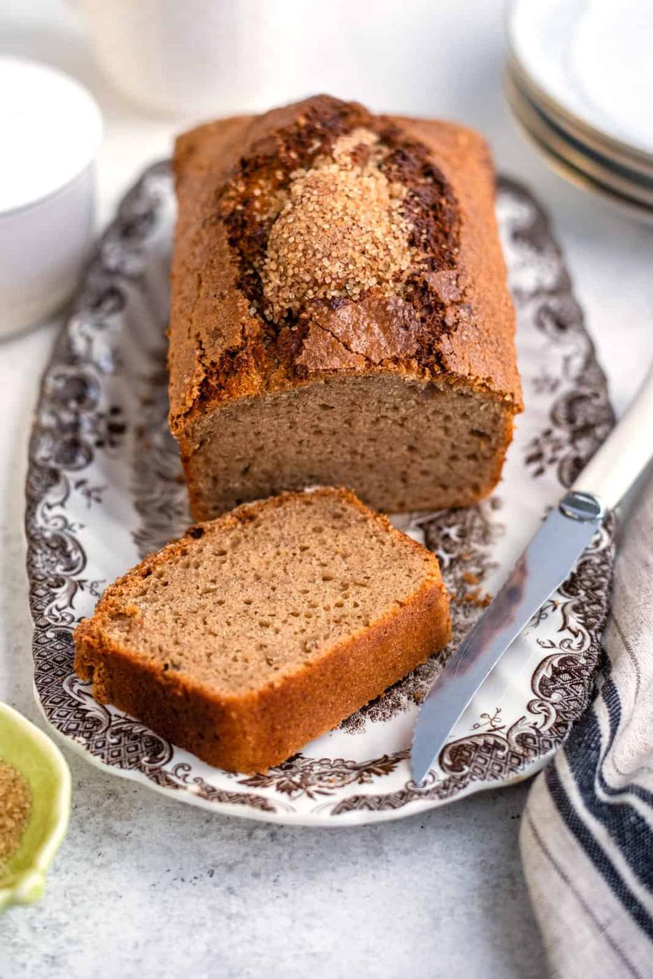 Loaf of air fryer banana bread with one slice cut