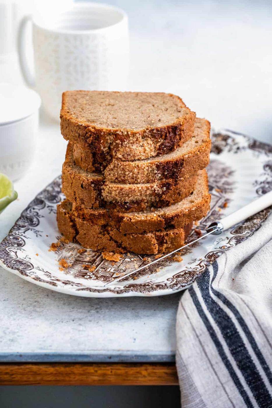 Air fryer banana bread loaf, sliced and stacked on a plate