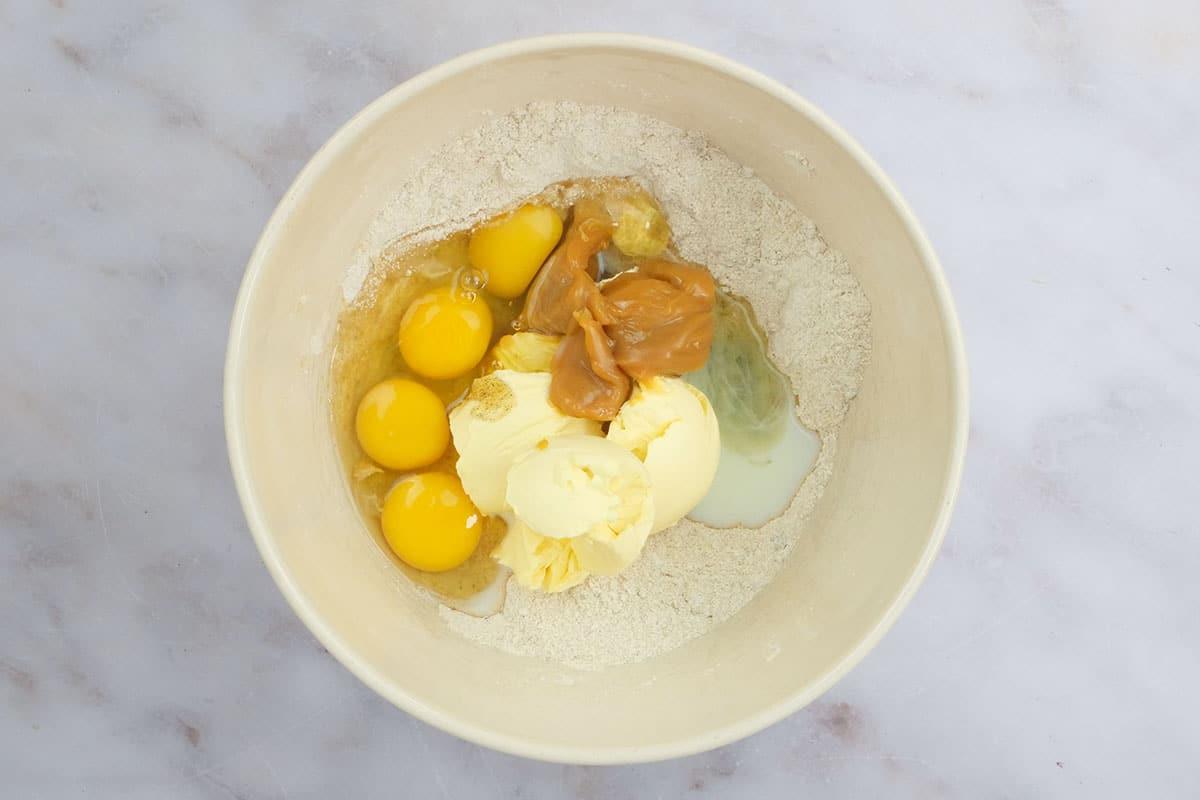 All the ingredients for Biscoff cake in a large mixing bowl