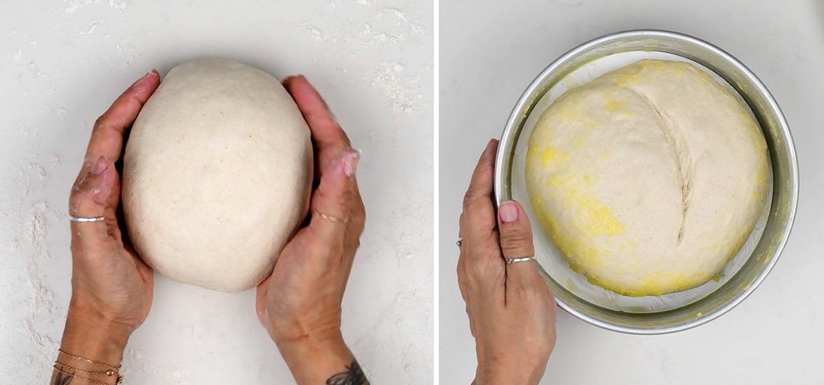 A shaped, floured round loaf of air fryer bread dough scored with a knife in a greased cake pan, ready to bake in the air fryer basket.