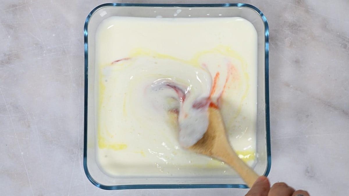 mixing ingredients for buttermilk marinade in a glass container
