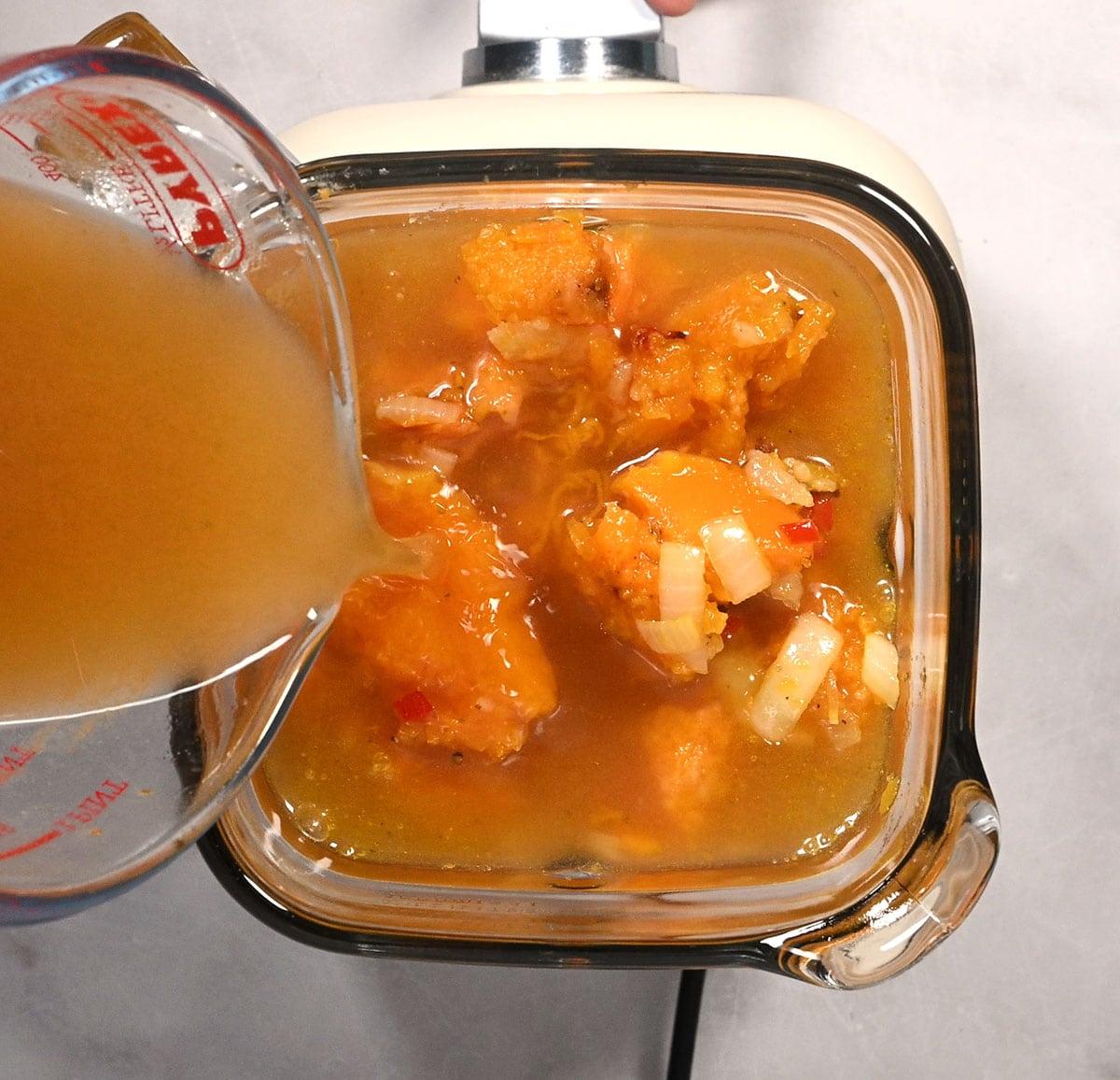 Blending the butternut squash soup until smooth