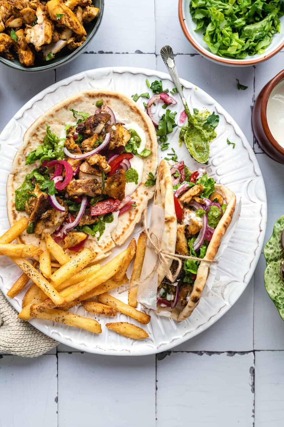 Air fryer chicken sharwama served with flatbreads, tomatoes, onions, lettuce, pickles