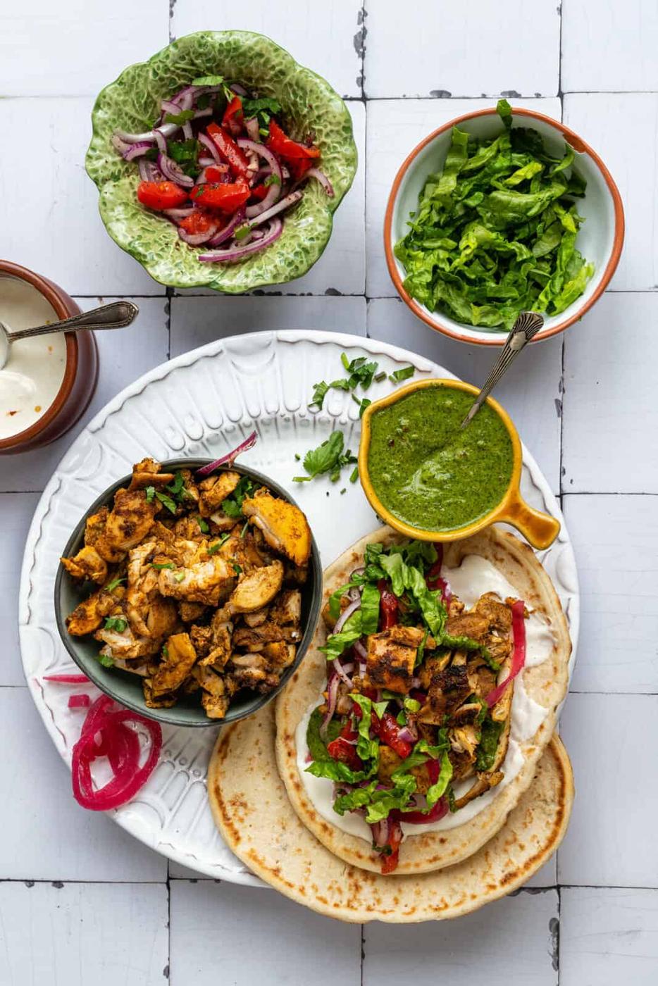 Air Fryer chicken sharwama on a plate with flatbreads and other fixings