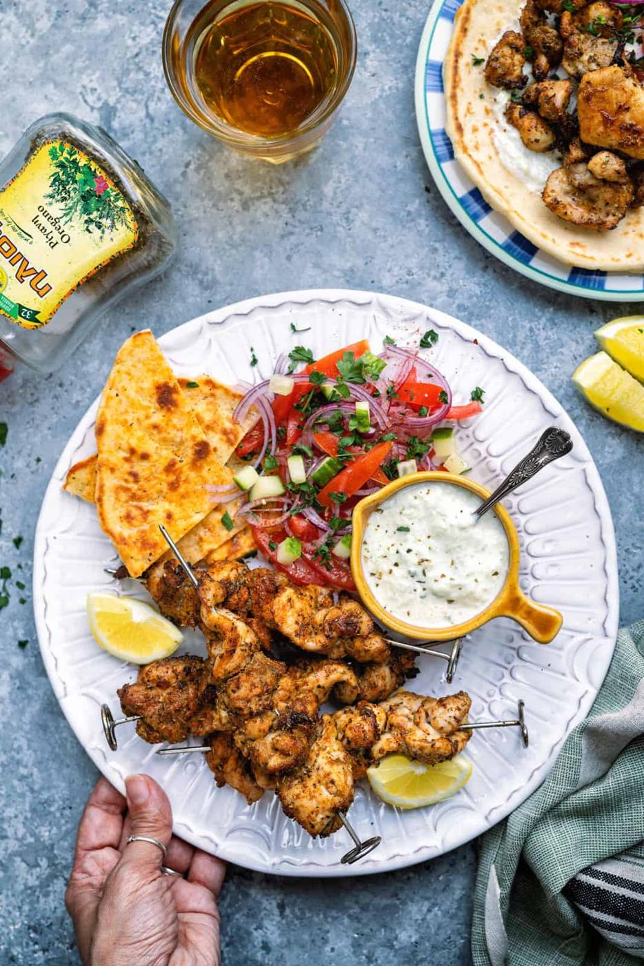 Air Fryer Souvlaki o a plate with tzatziki, pita and Greek salad
