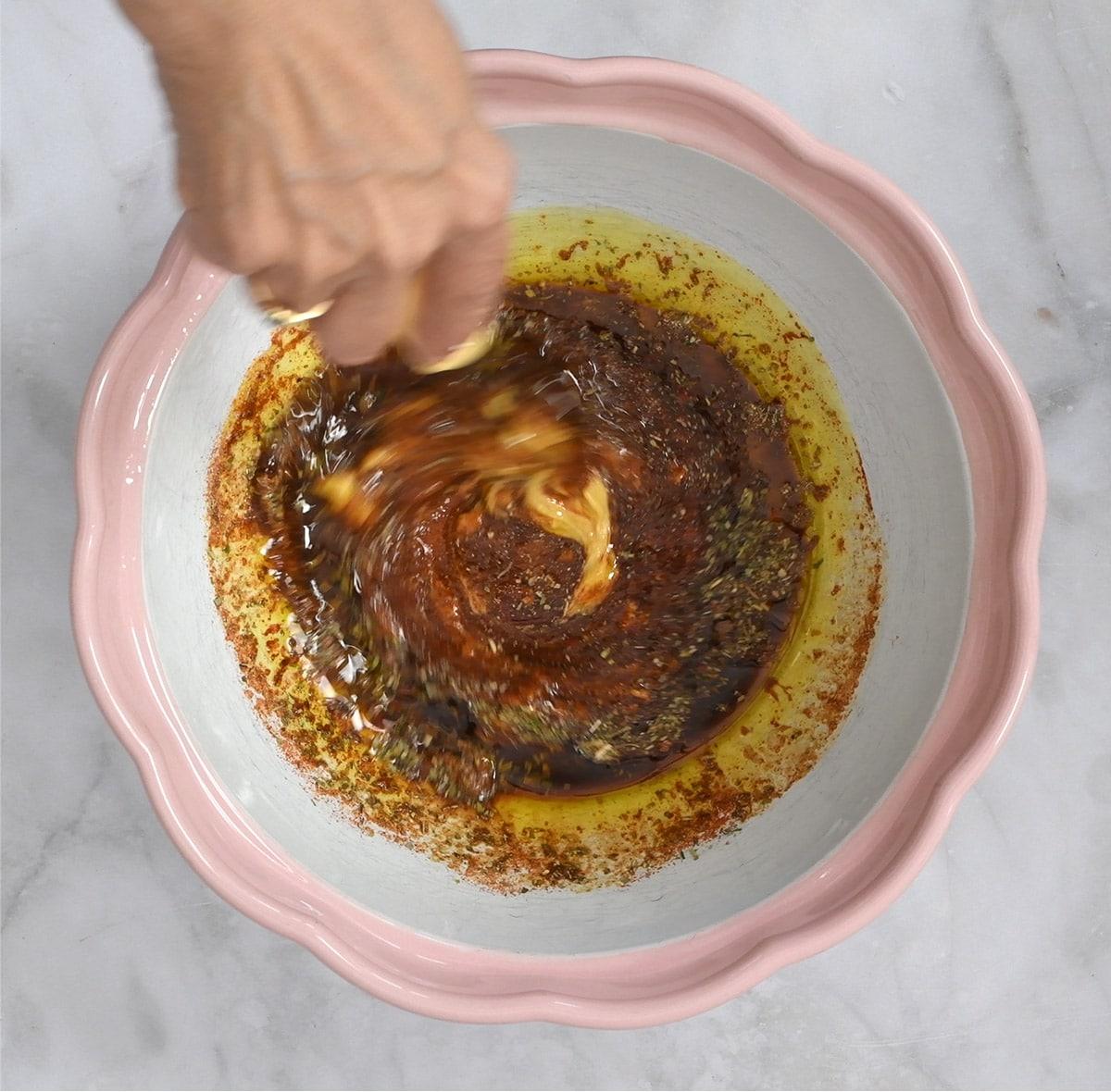 mixing up chicken marinade in a bowl