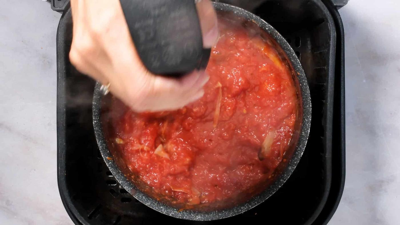 blending curry sauce with an immersion blender