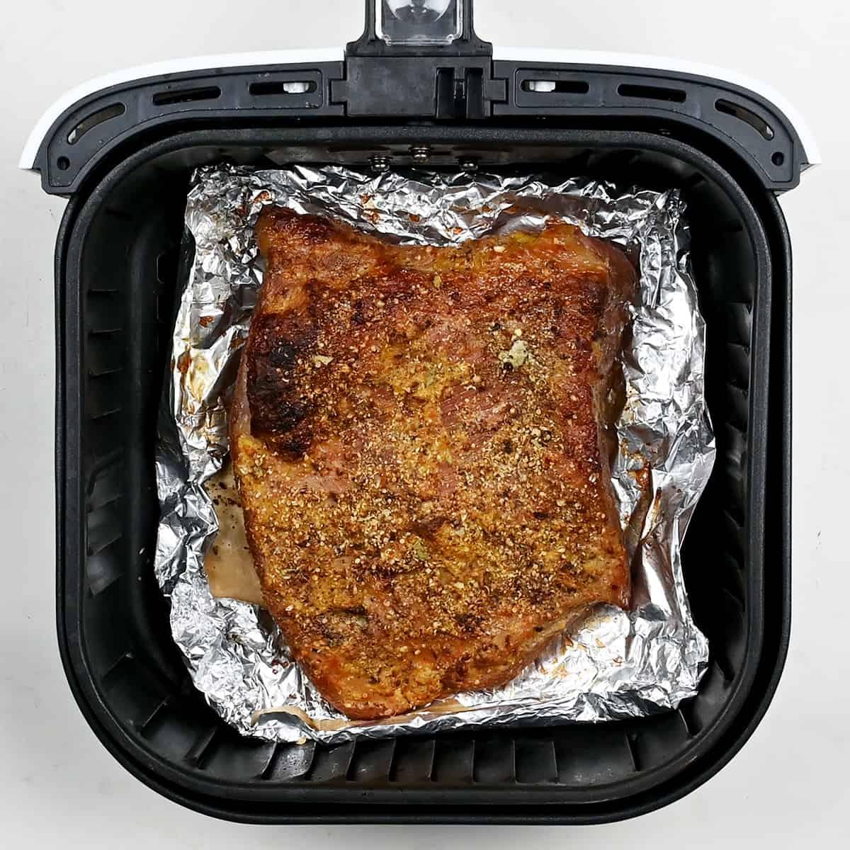 Corned beef brisket in the basket of an air fryer