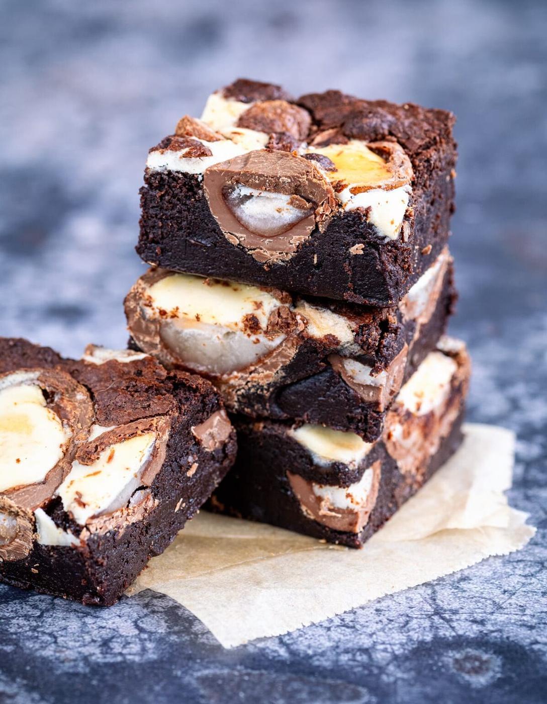 Sliced Creme Egg Brownies, three stacked, one on the side