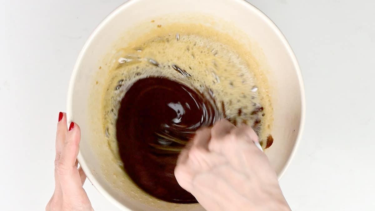 Stirring melted butter and chocolate in a mixing bowl