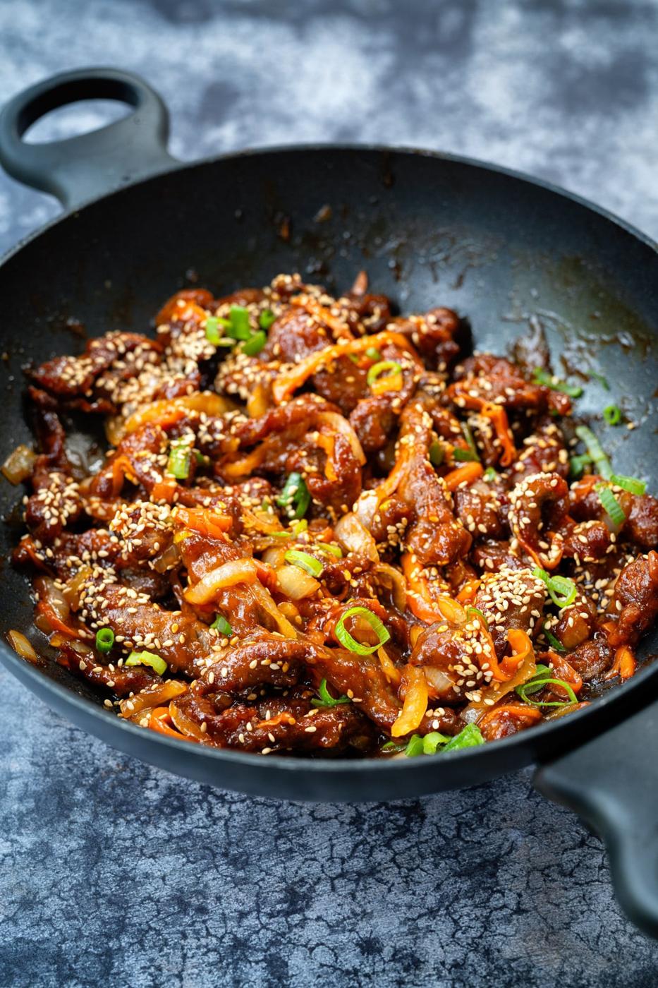 Chinese shredded crispy beef in a wok, side view