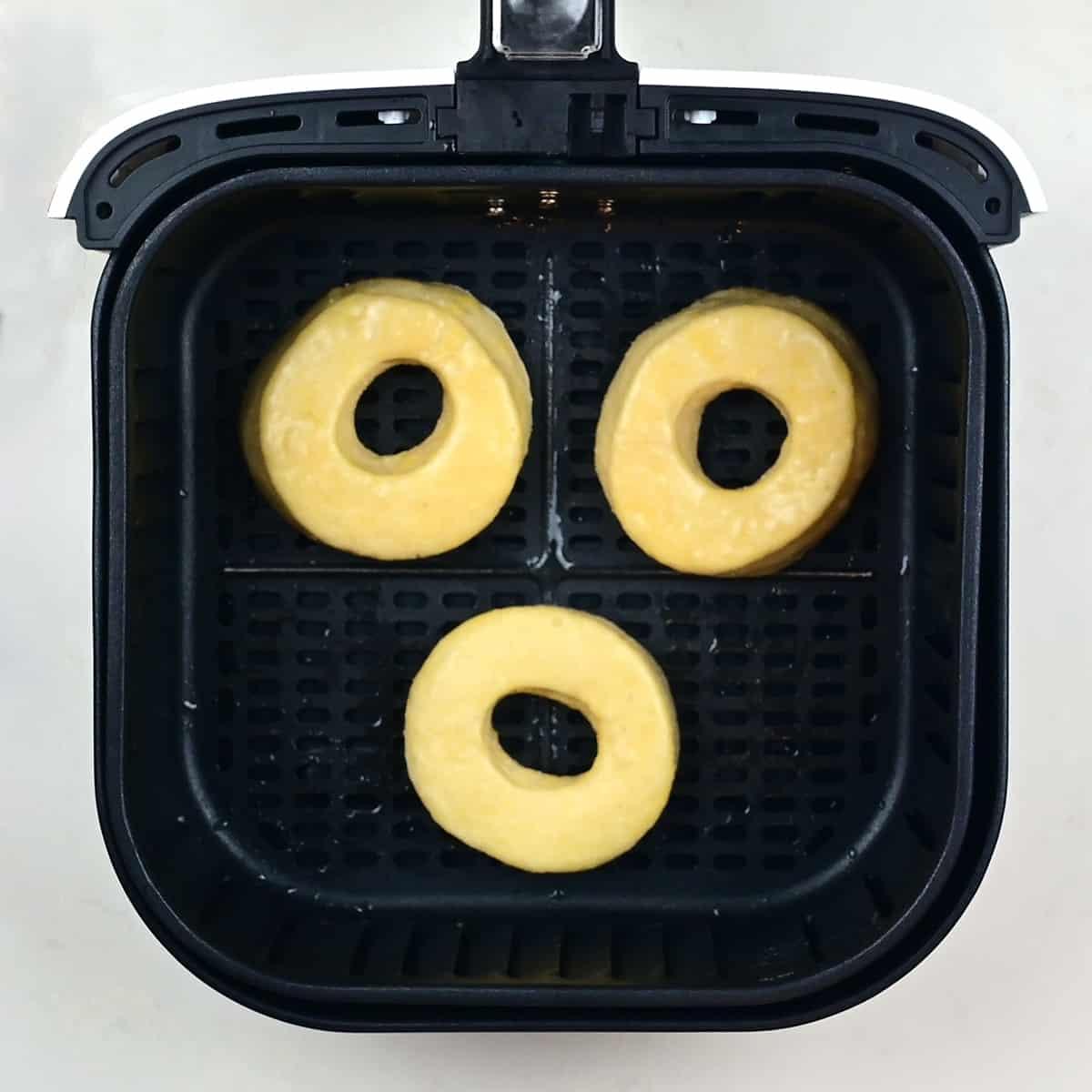 Donuts cooking in an air fryer
