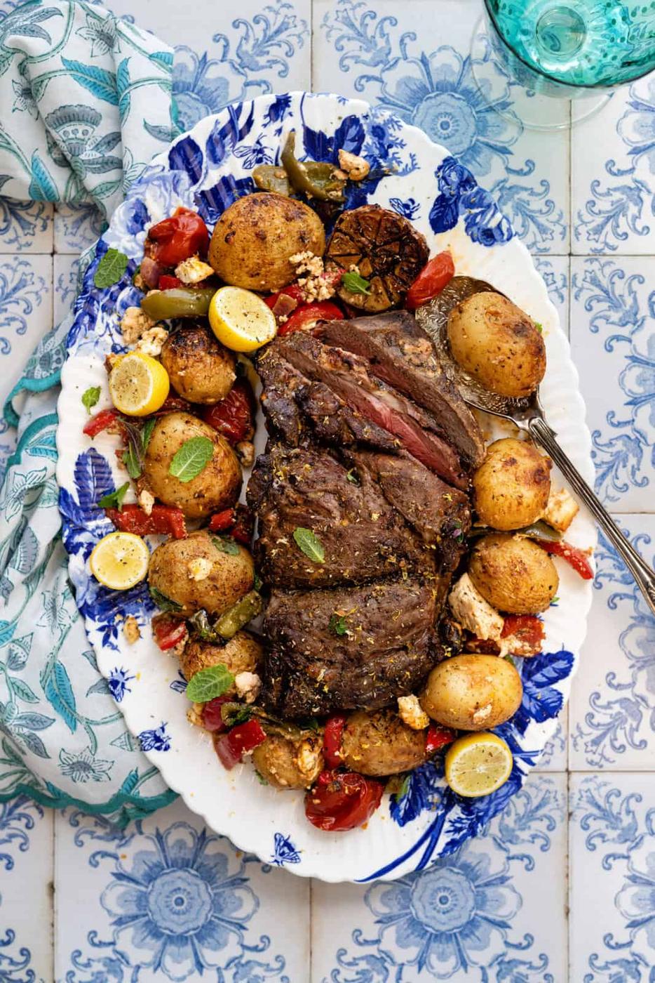 Greek Lamb Kleftiko on a platter with vegetables and feta