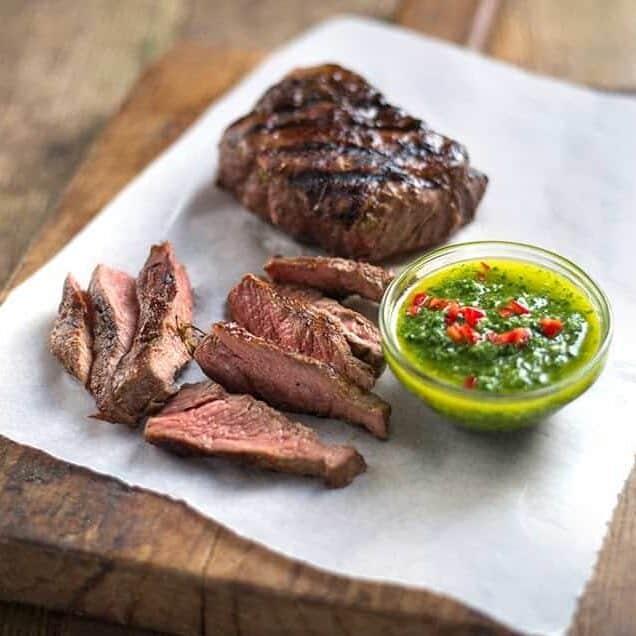 steak with chimichurri sauce on the side