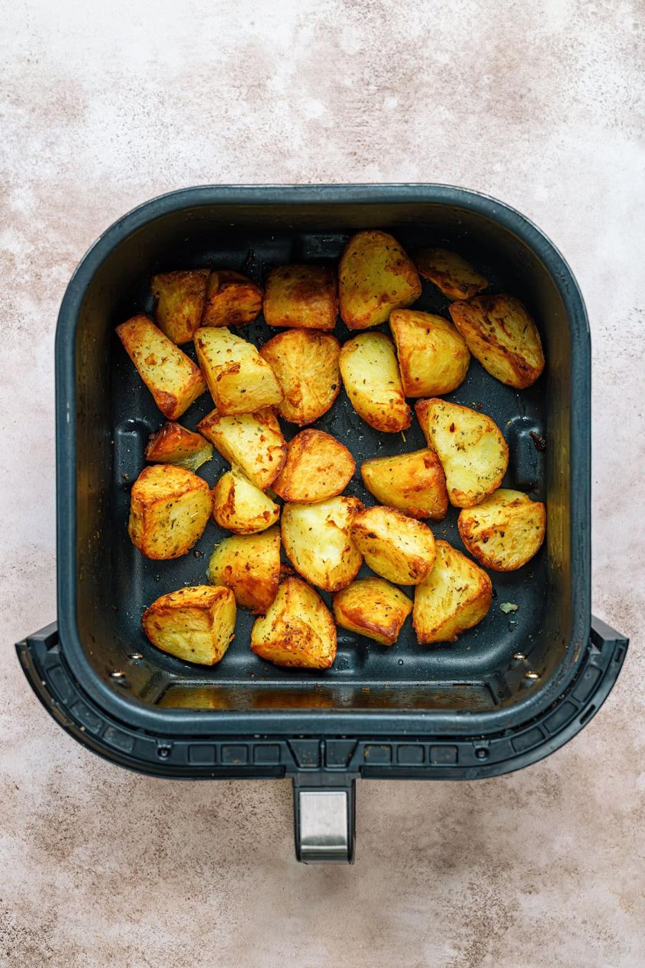 roast potatoes in the basket of an air fryer