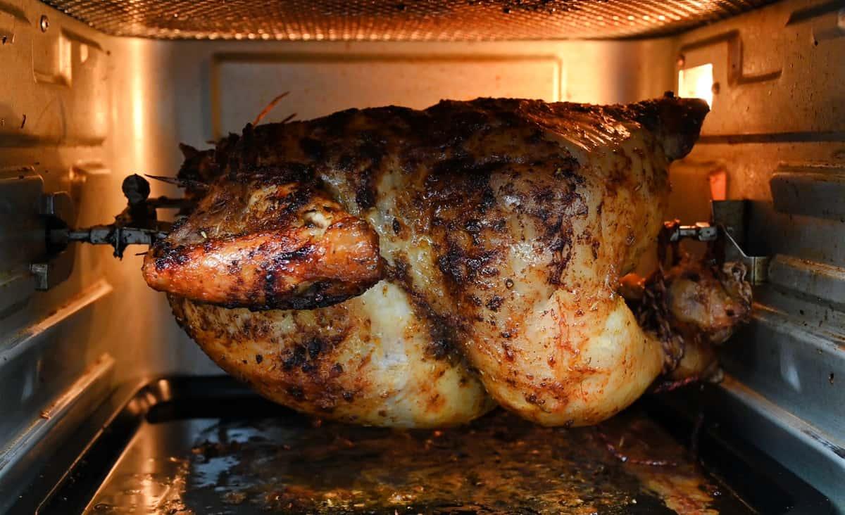 Chicken cooking on a rotisserie air fryer