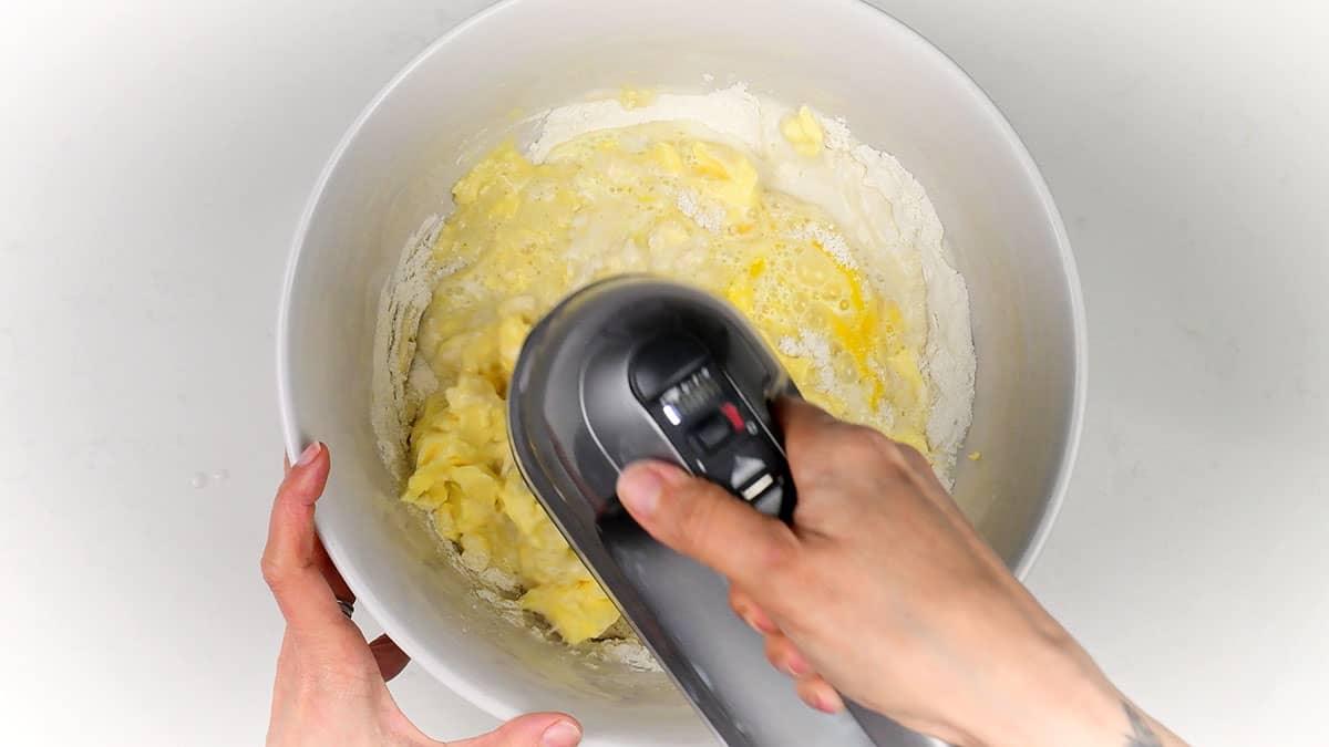 Beating vanilla cake batter using an electric hand mixer