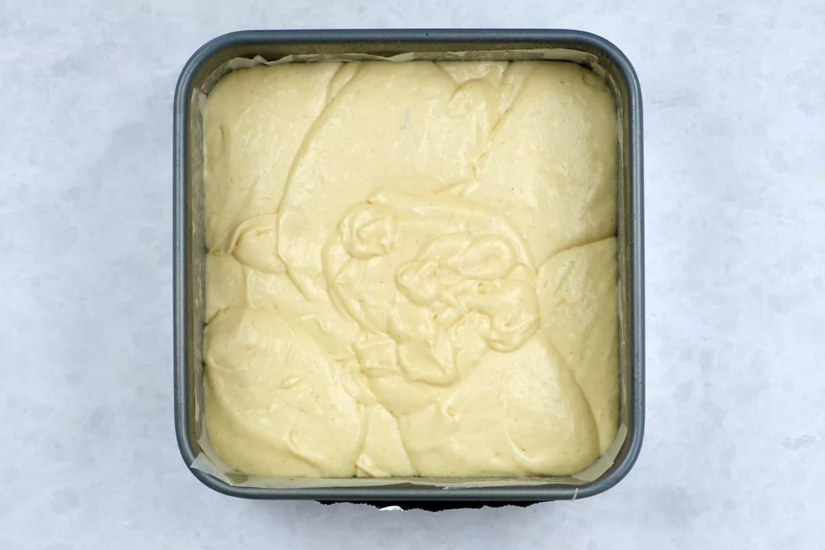 Vanilla cake batter in a square cake pan