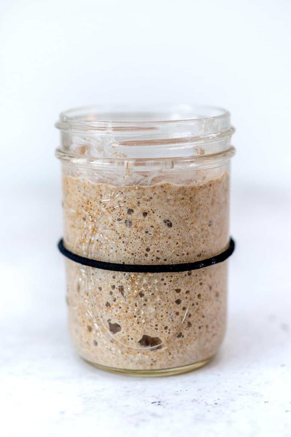 Bubbly sourdough starter in a glass jar