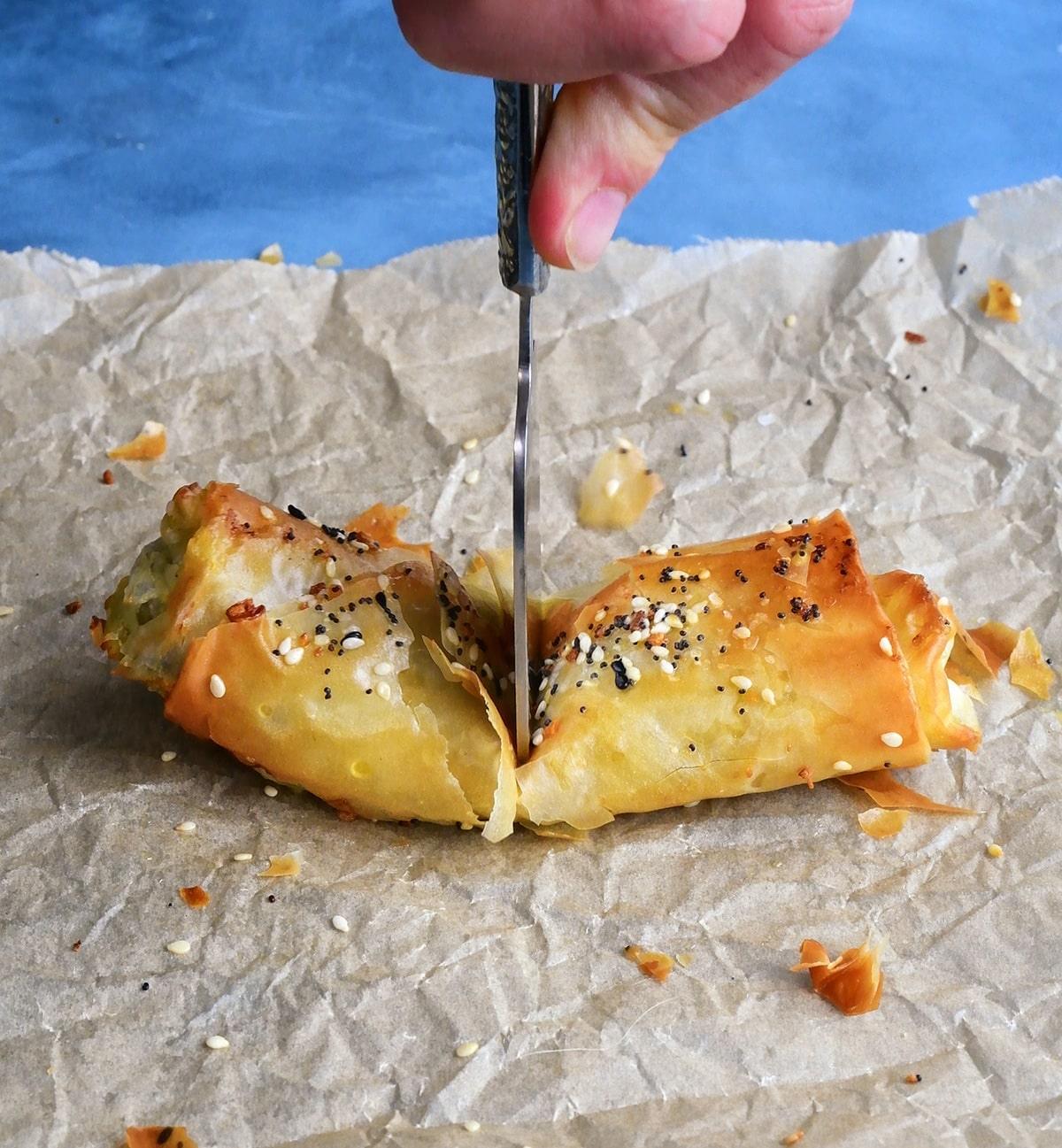 Spinch and feta roll being cut in half