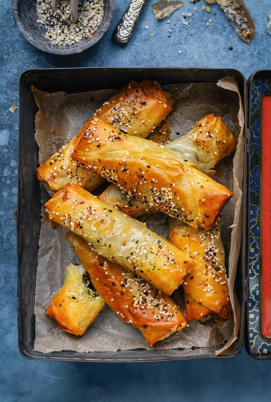 Greek spanakopita rolls in a small tin