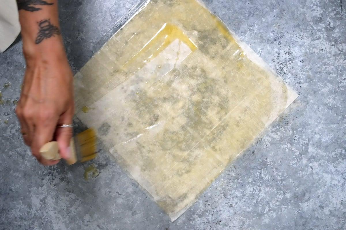 brushing phyllo pastry with melted butter