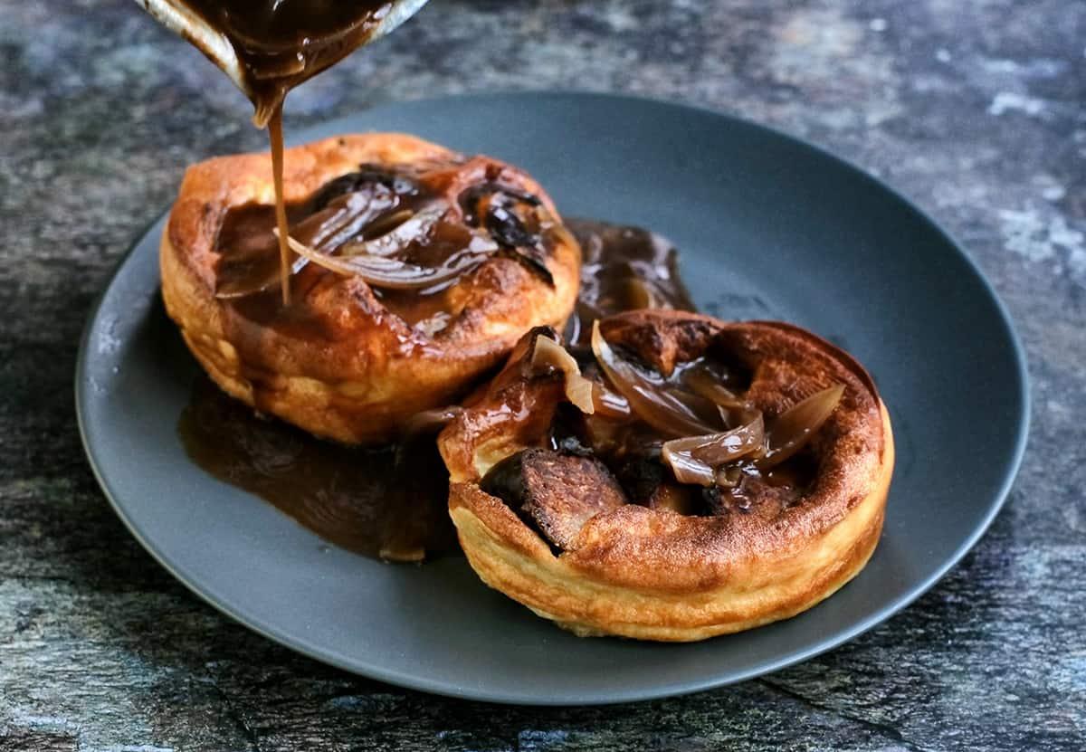 mini toad in the hole with gravy on a plate