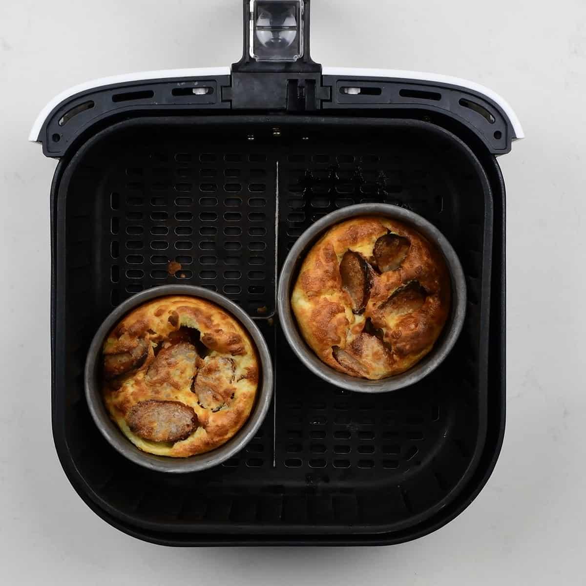 Two cake pans with toad in the hole in a Cosori Air Fryer basket