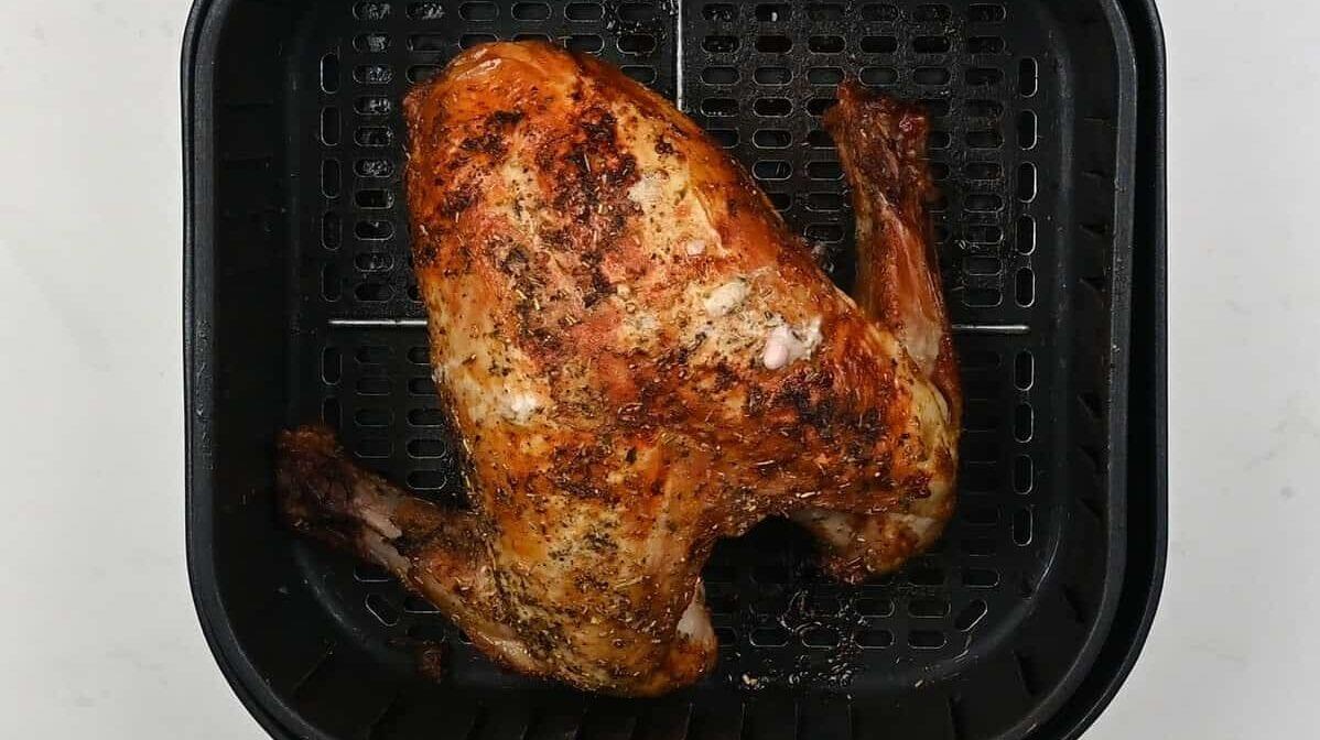 Cooked turkey breast in an air fryer basket