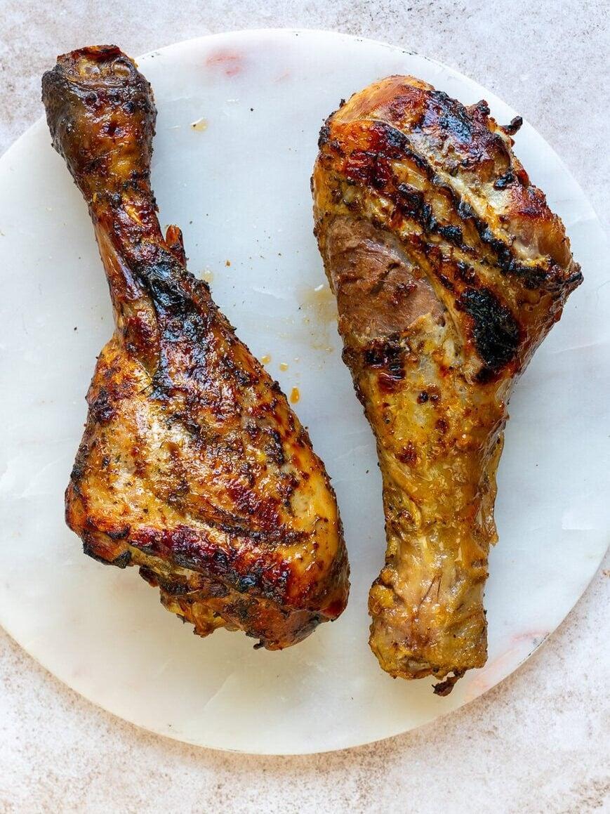 turkey drumsticks on a marble board