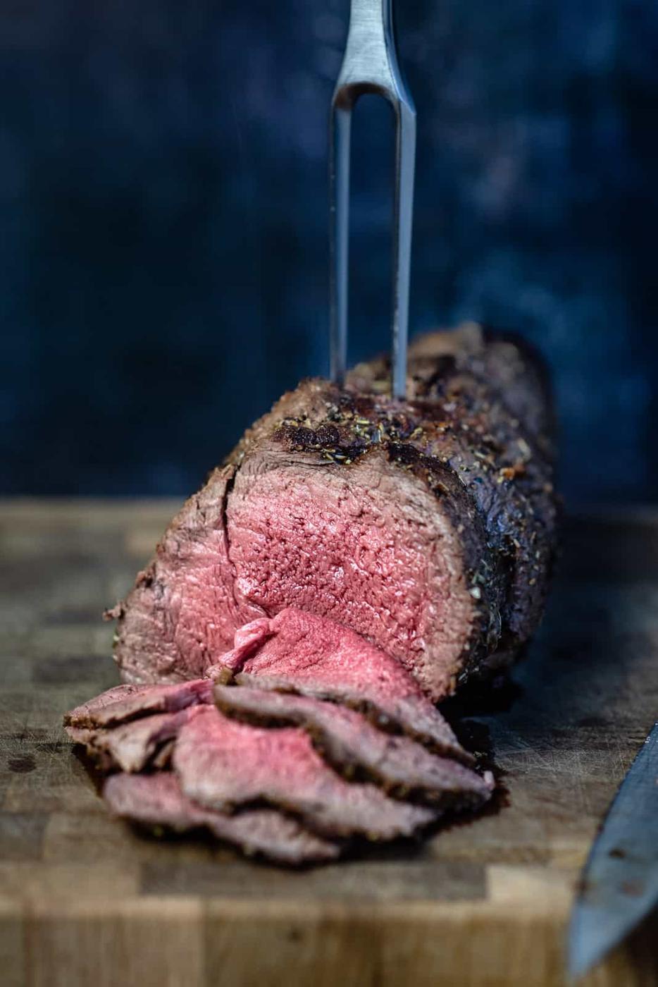 Roasted Venison, some sliced,on a cutting board