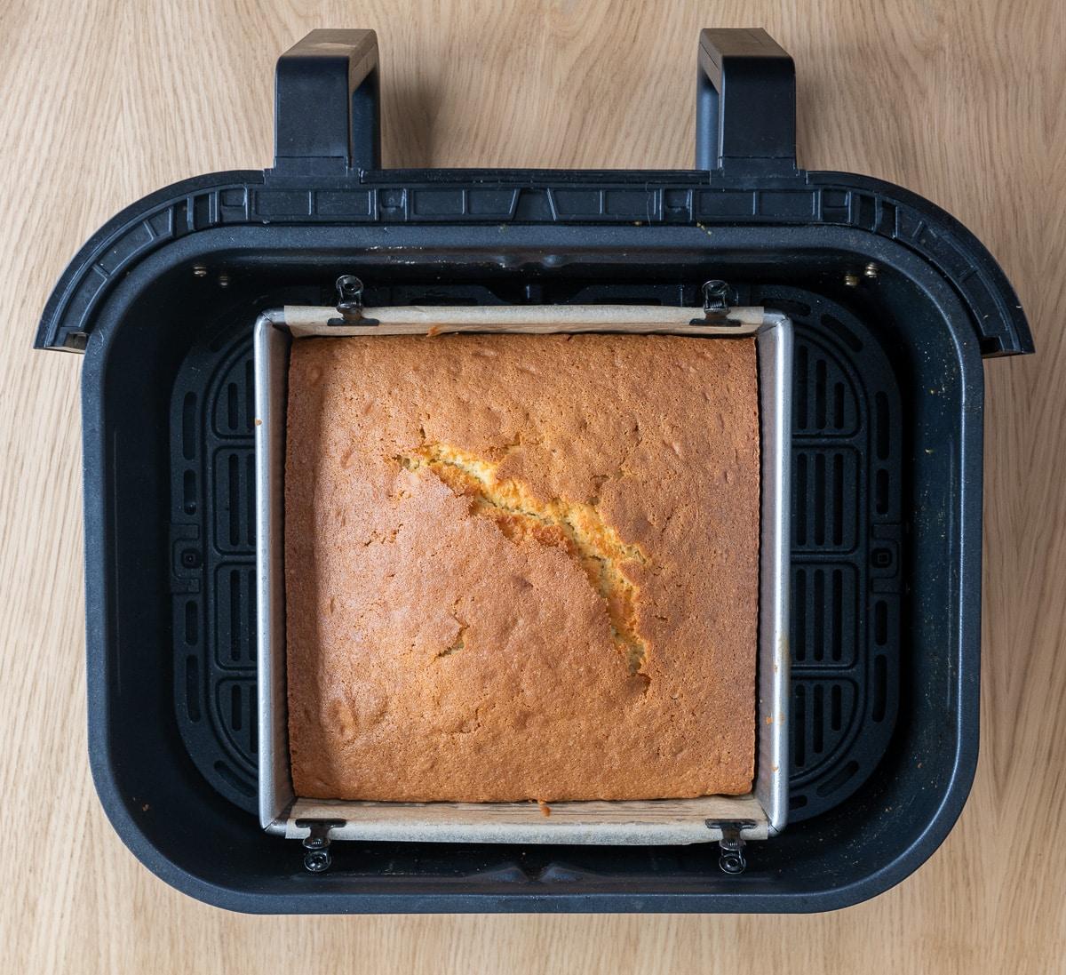 Square sponge cake in the basket of an air fryer