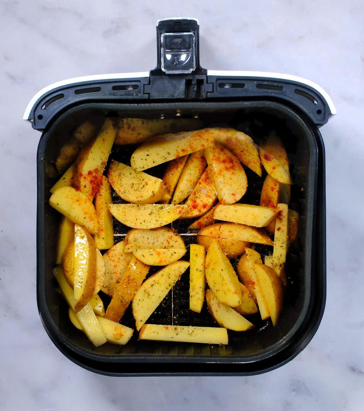 seasoned potato wedges in the air fryer basket