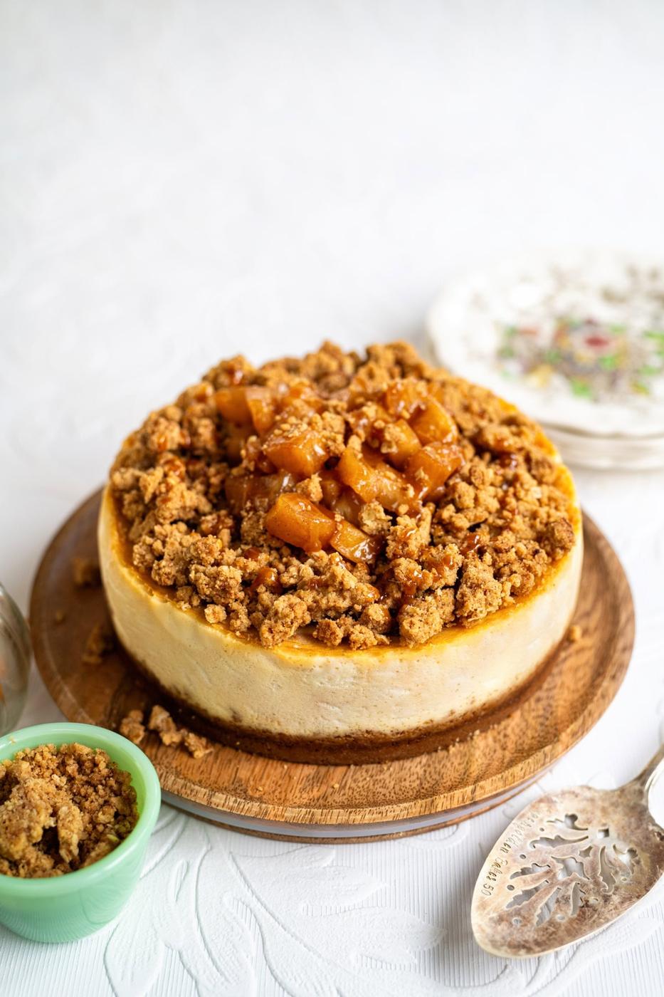 Apple crumble cheesecake, small bowl of crumble topping on the side