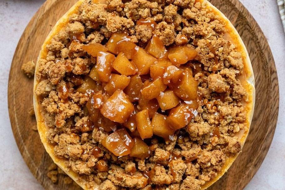 overhead view of apple crumble cheesecake topped with apple compote and crumble topping
