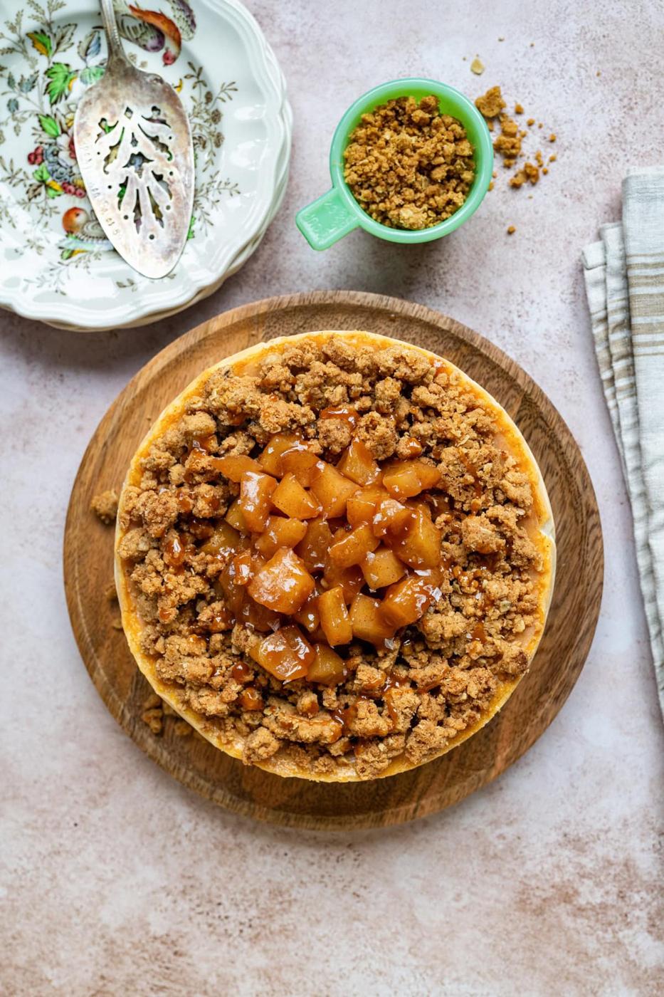 overhead view of apple crumble cheesecake topped with apple compote and crumble topping