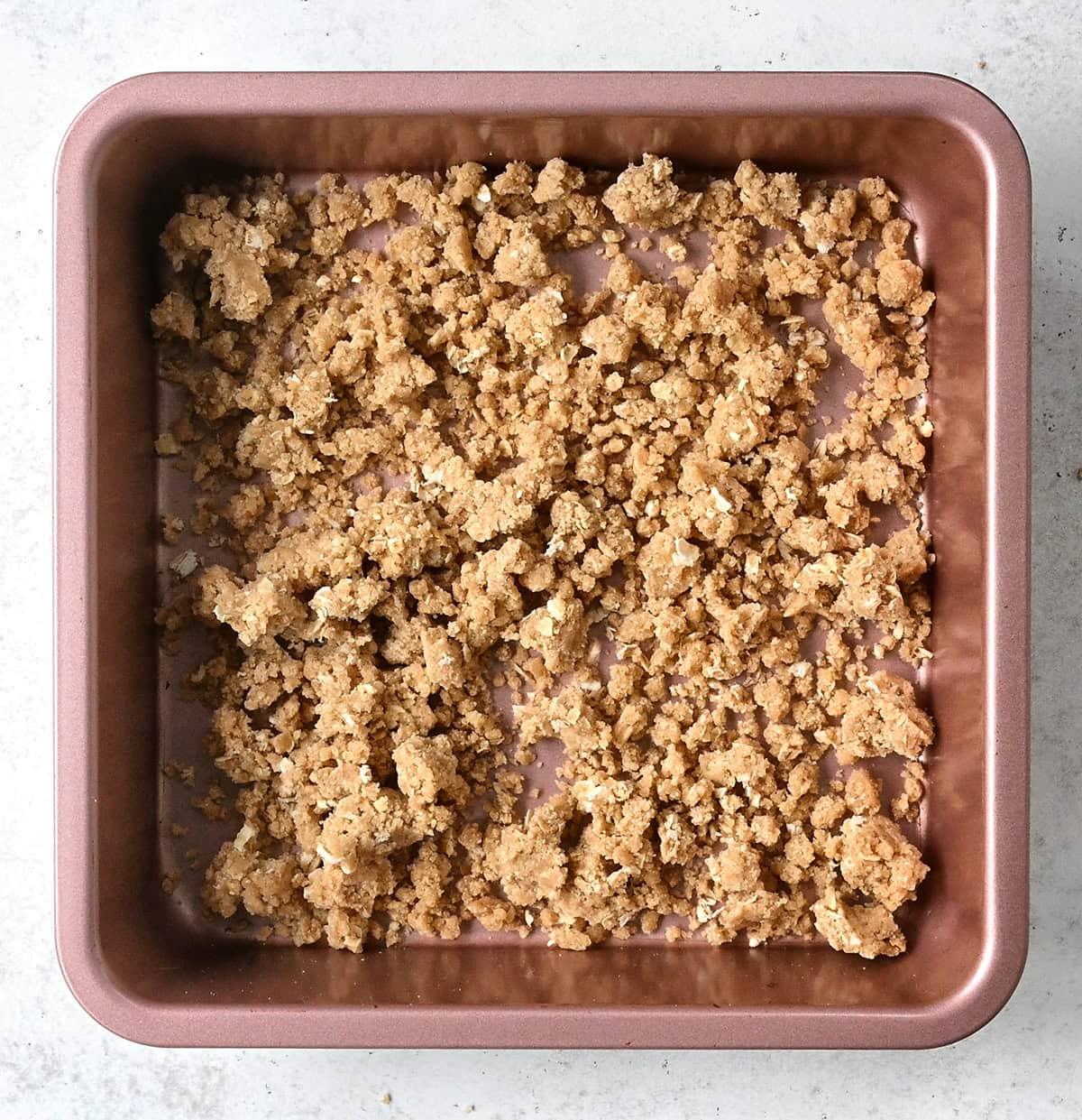crumble topping spread in a square pan