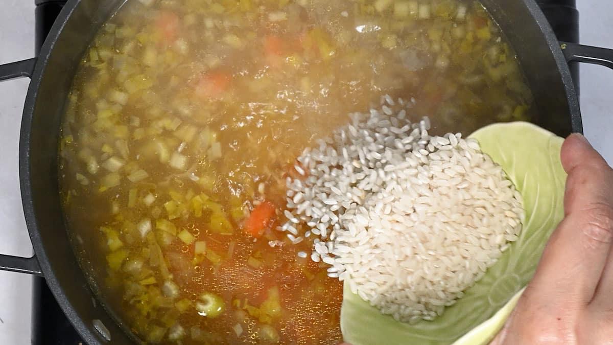 adding rice to chicken soup