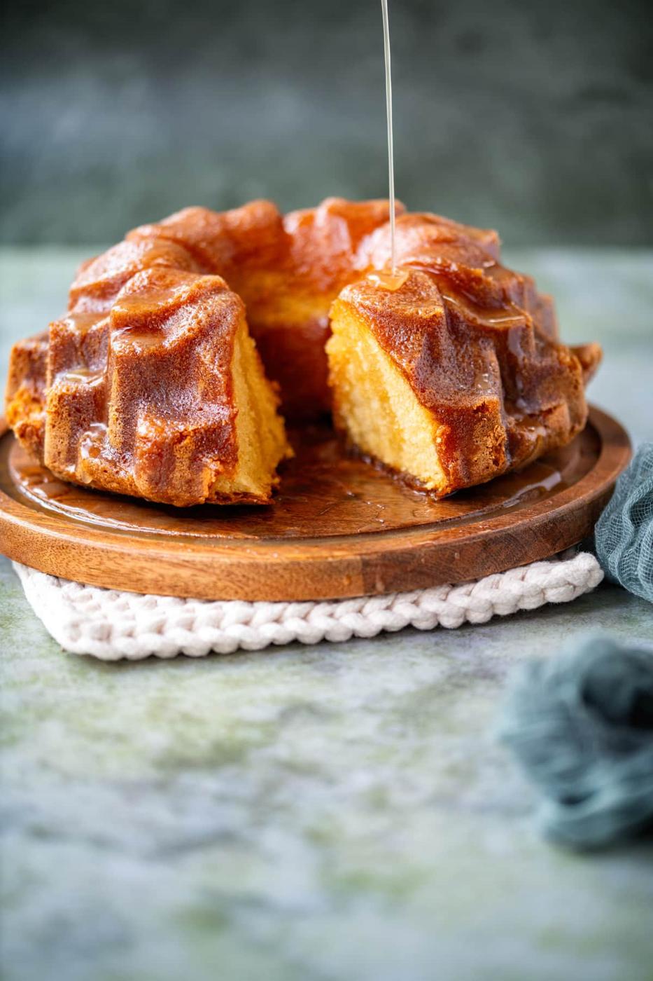 Sliced rum cake on a wooden plate