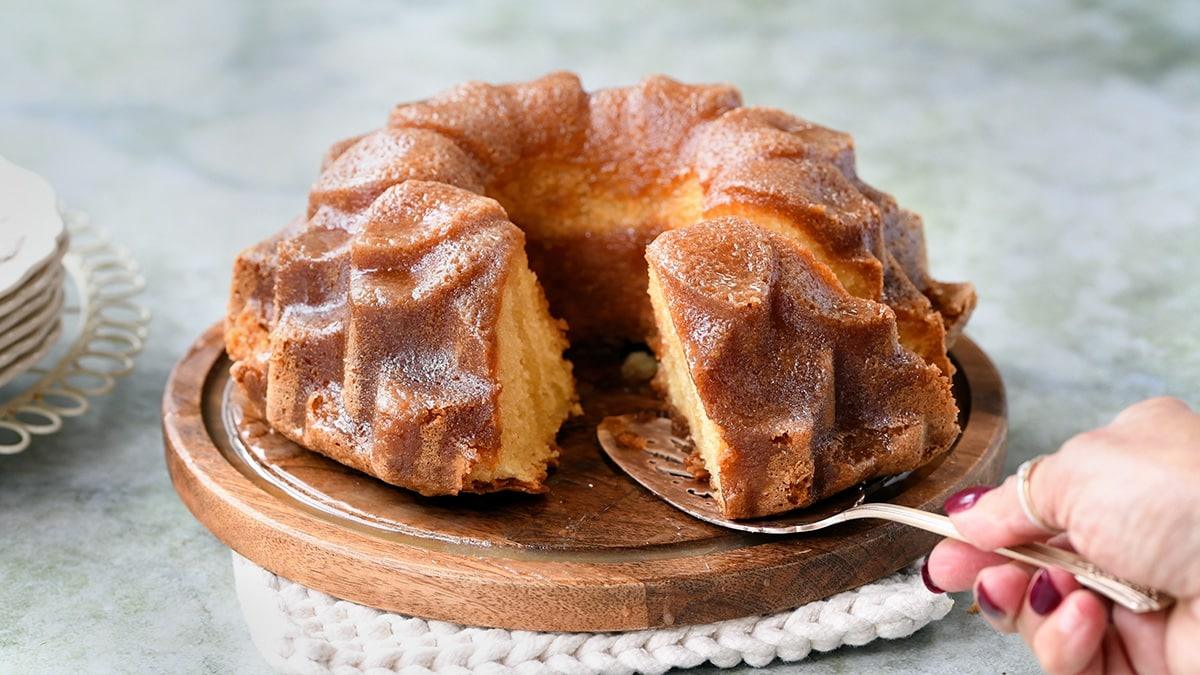 Cutting a slice of rum cake
