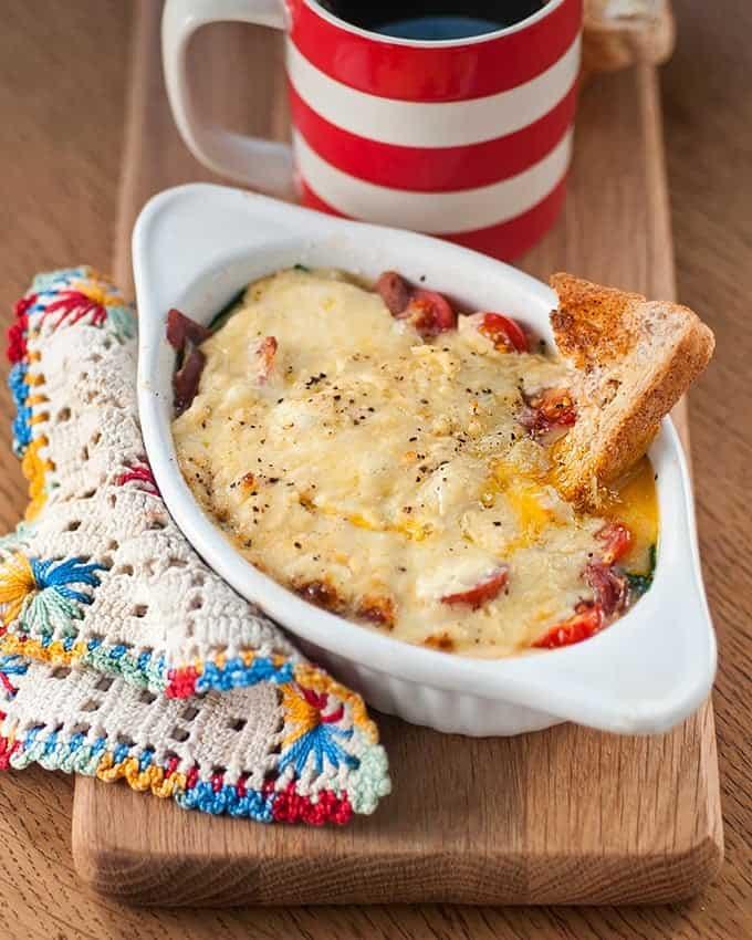 Baked eggs with spinach, Gruyère and tomatoes