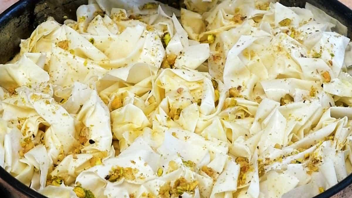 Baklava cake topped with phyllo pastry ready for the oven
