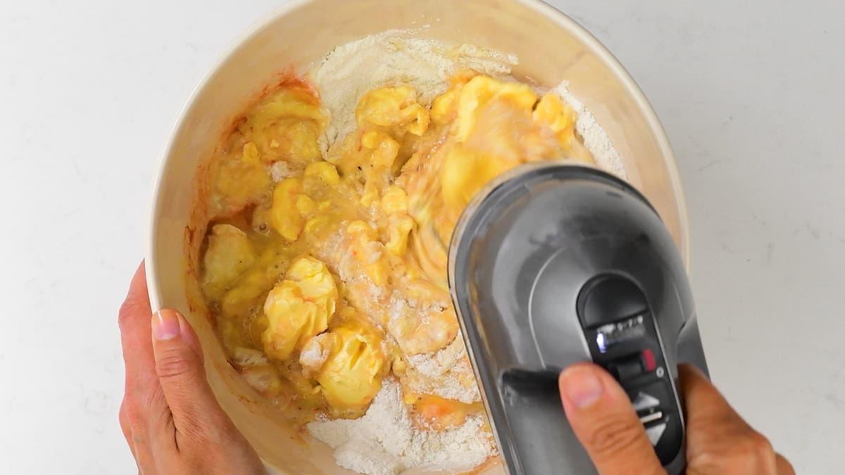 Whisking banana cake batter in a bowl