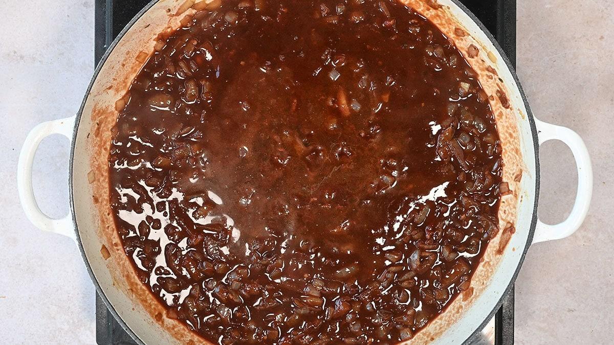 reducing sauce for short ribs in a skillet