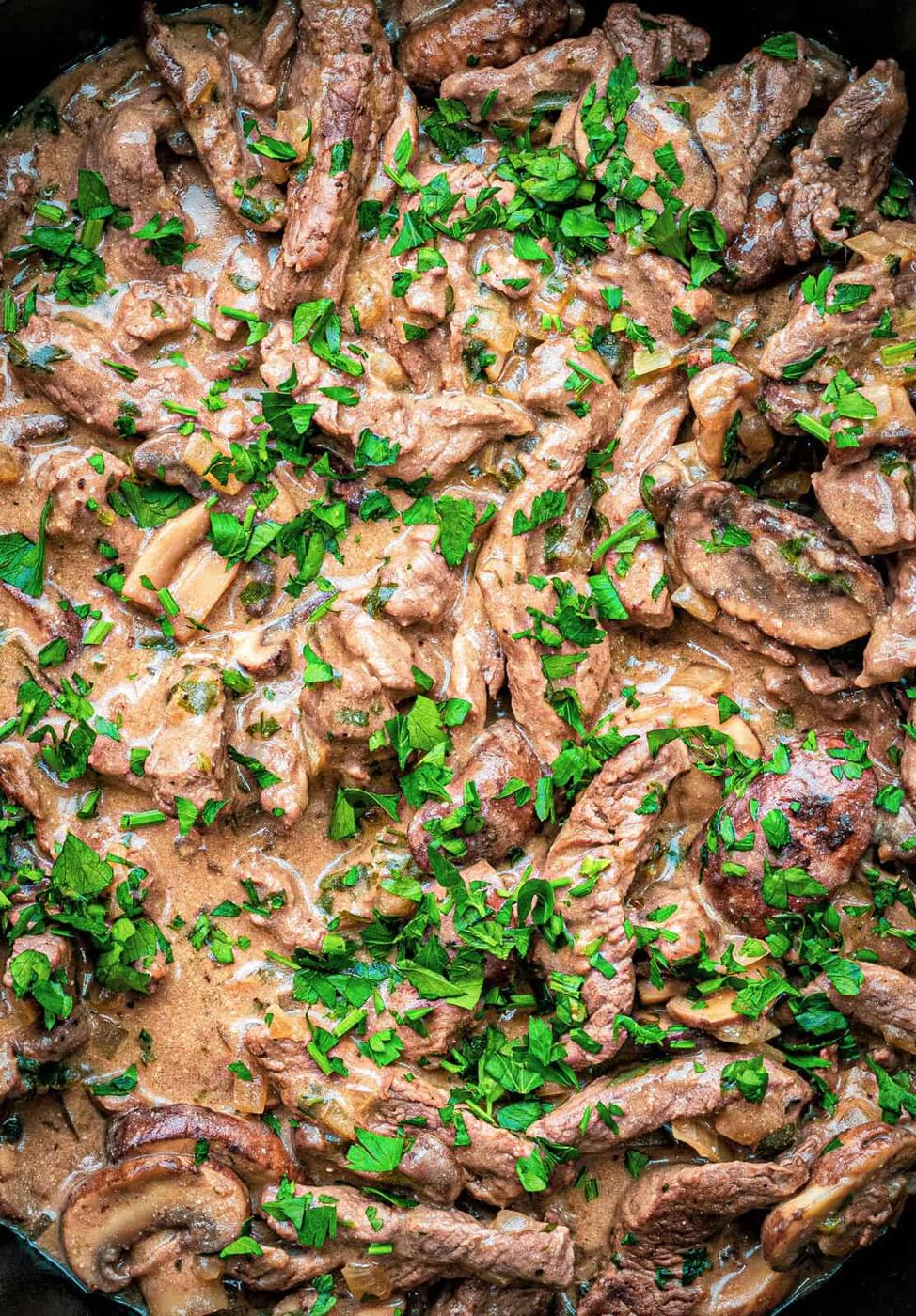 Close up on Stroganoff sauce with beef, mushrooms in sour cream gravy